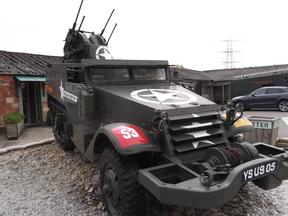 a military vehicle parked outside a building