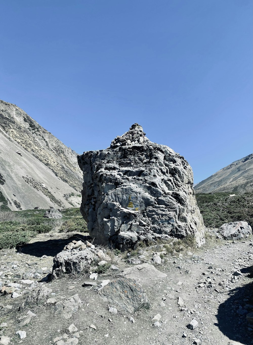 a large rock on a rocky hill