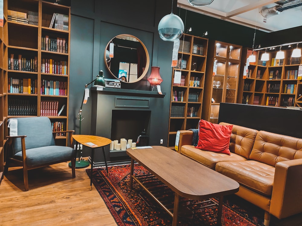 a living room with a fireplace and bookshelves