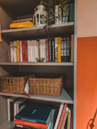 a bookshelf with books and a basket