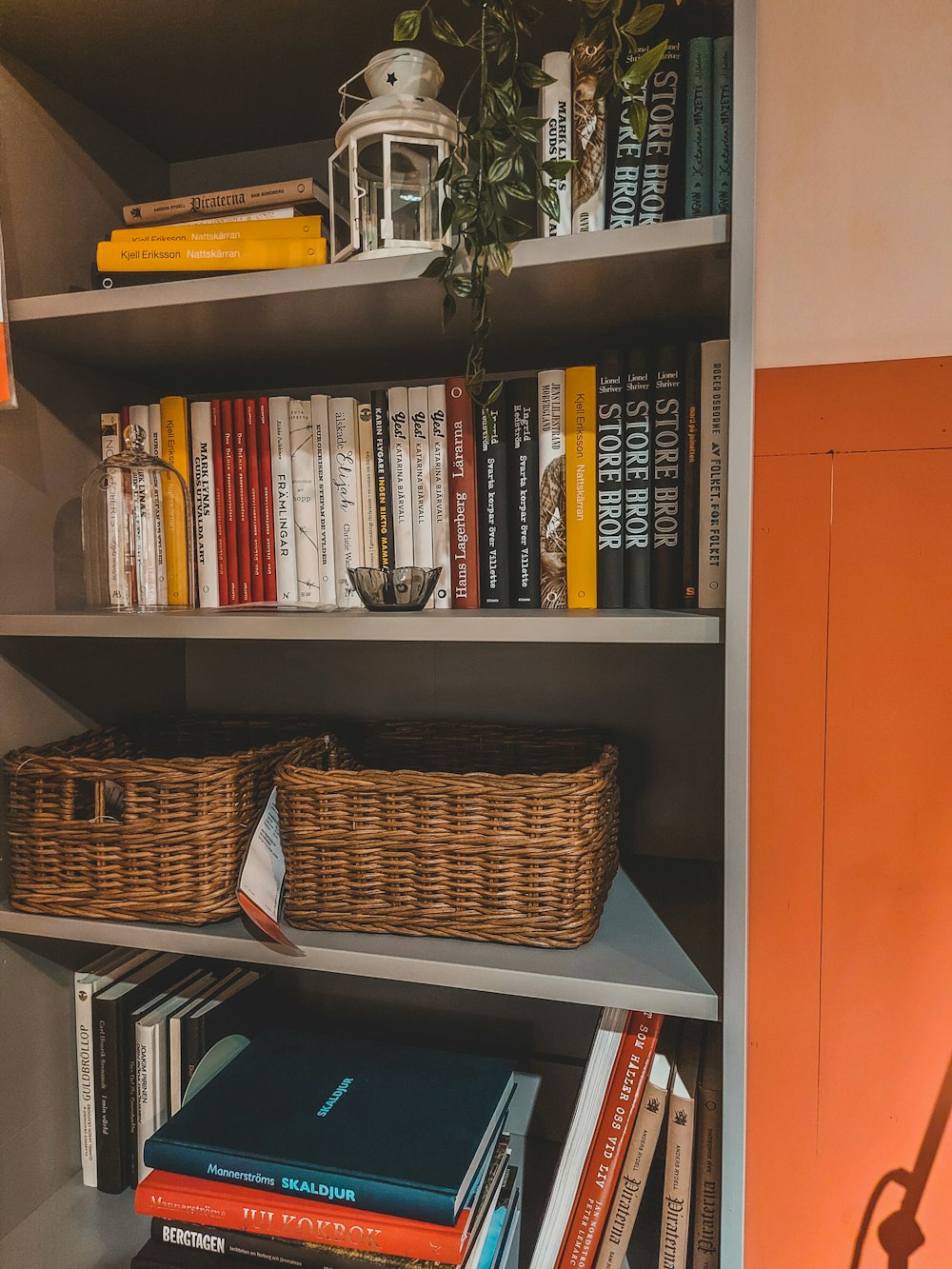 a bookshelf with books and a basket