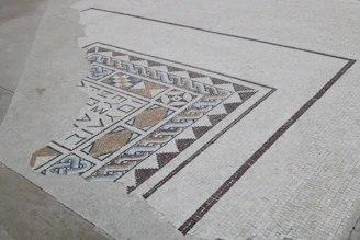 Close-up of a freshly installed mosaic tile floor with intricate patterns.