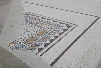 Close-up of a freshly installed marble shower floor with intricate mosaic details.