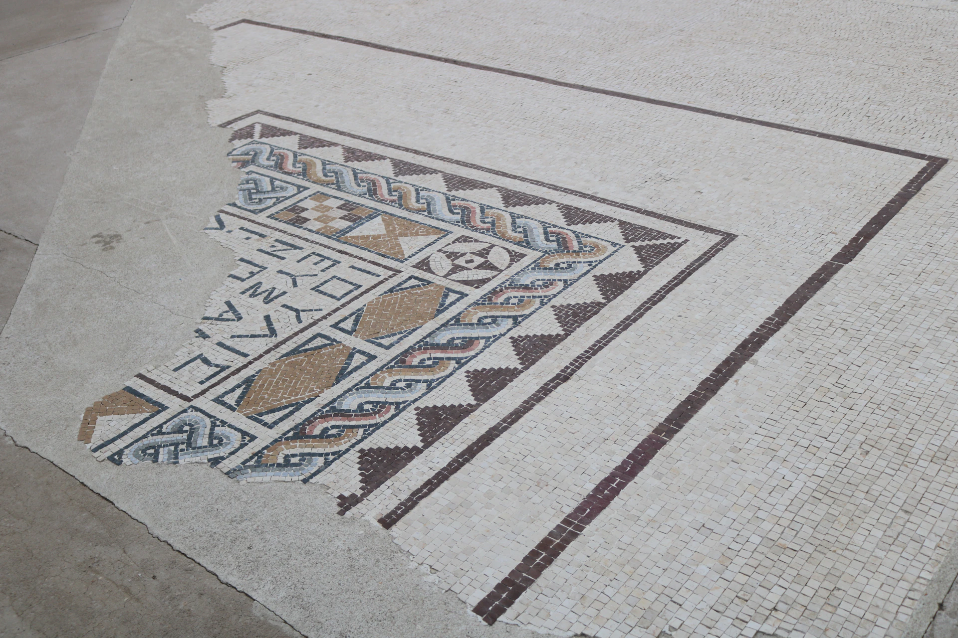 Close-up of a beautifully installed mosaic tile floor with intricate patterns and vibrant colors.