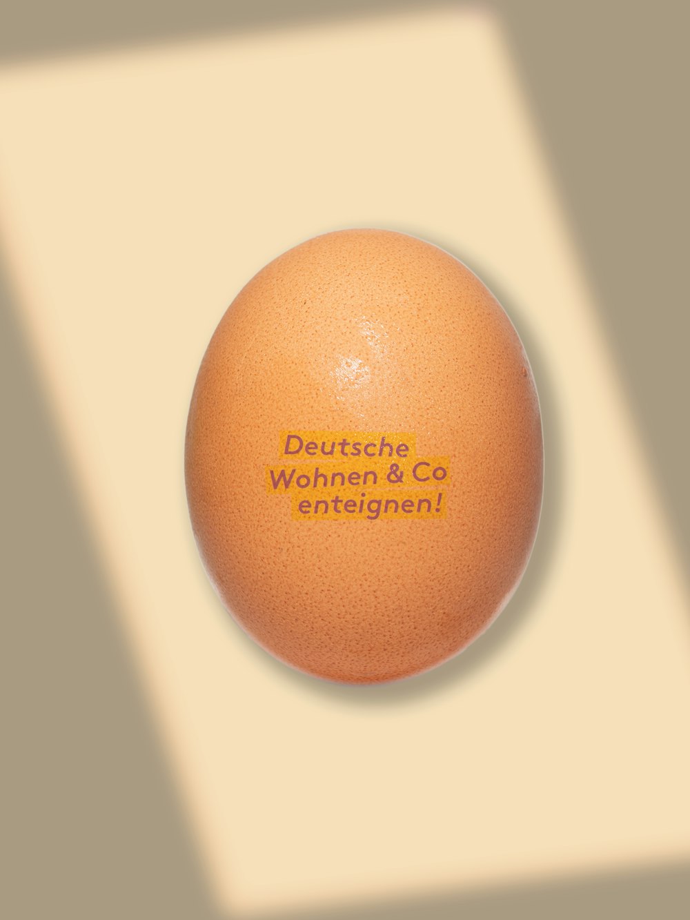 a brown egg on a white surface