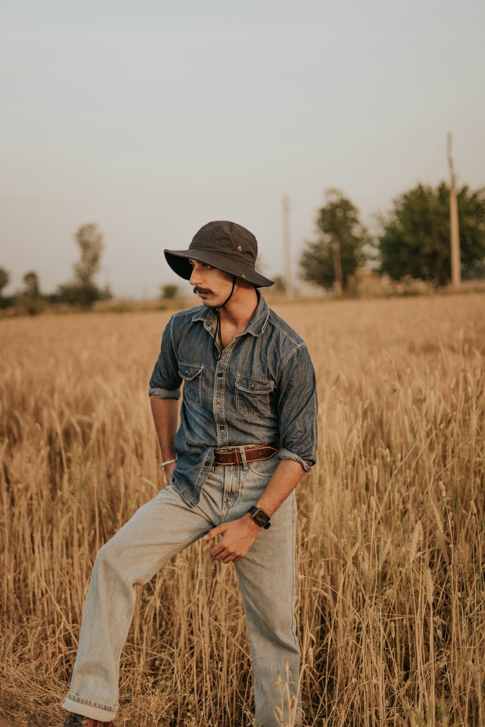 Ein Mann mit Hut steht auf einem Feld