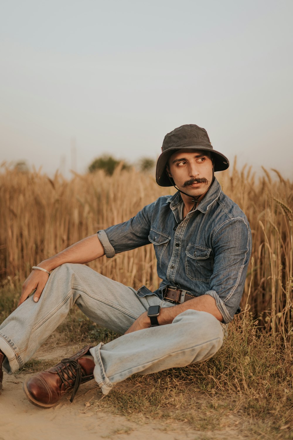 a man sitting in a field