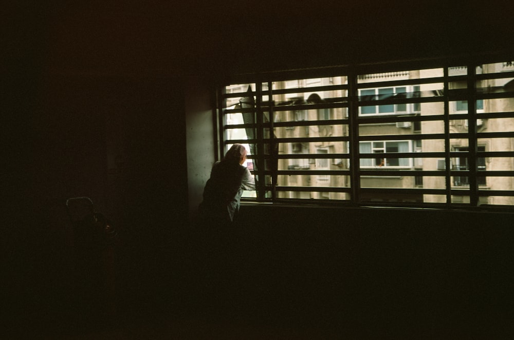 a couple of people looking out a window