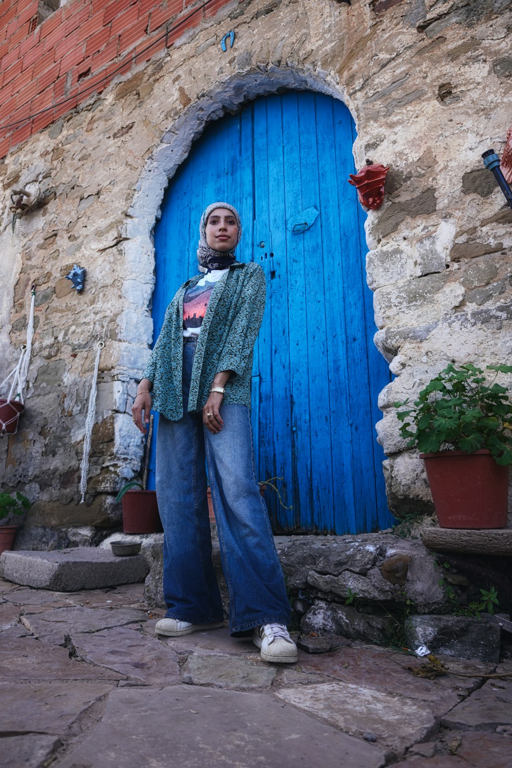 a person standing in front of a blue door