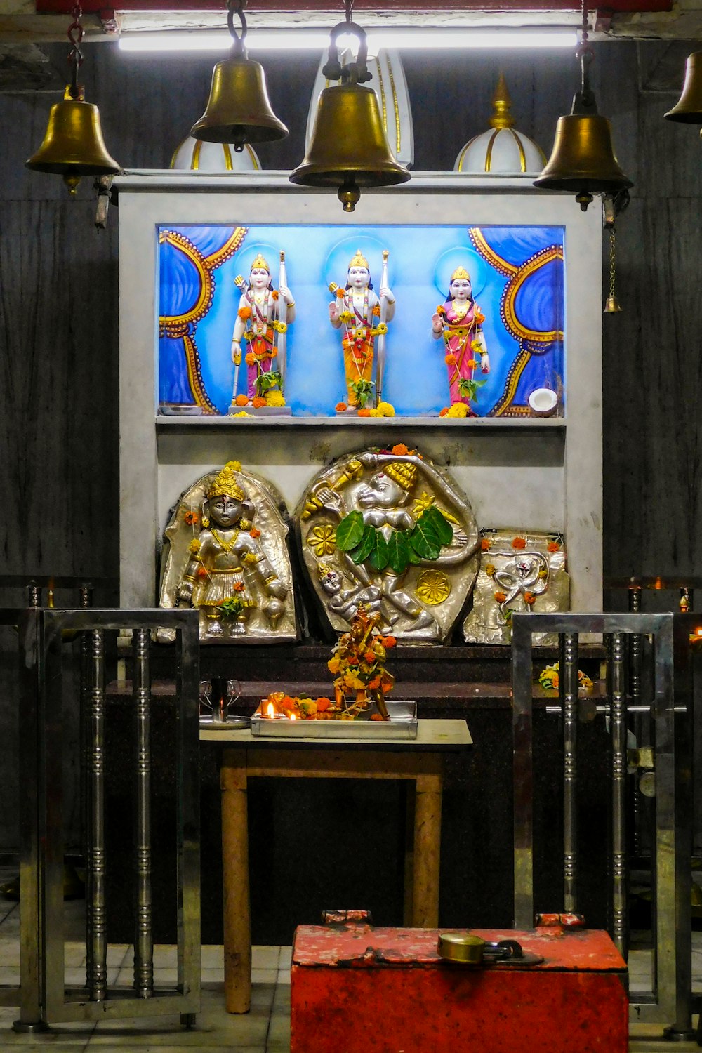 a shelf with bells and statues