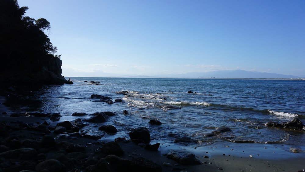 a rocky beach with waves crashing