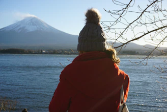 two people facing a body of water