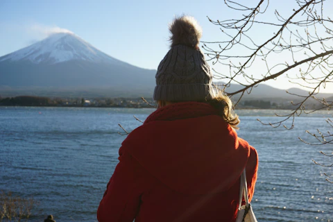two people facing a body of water