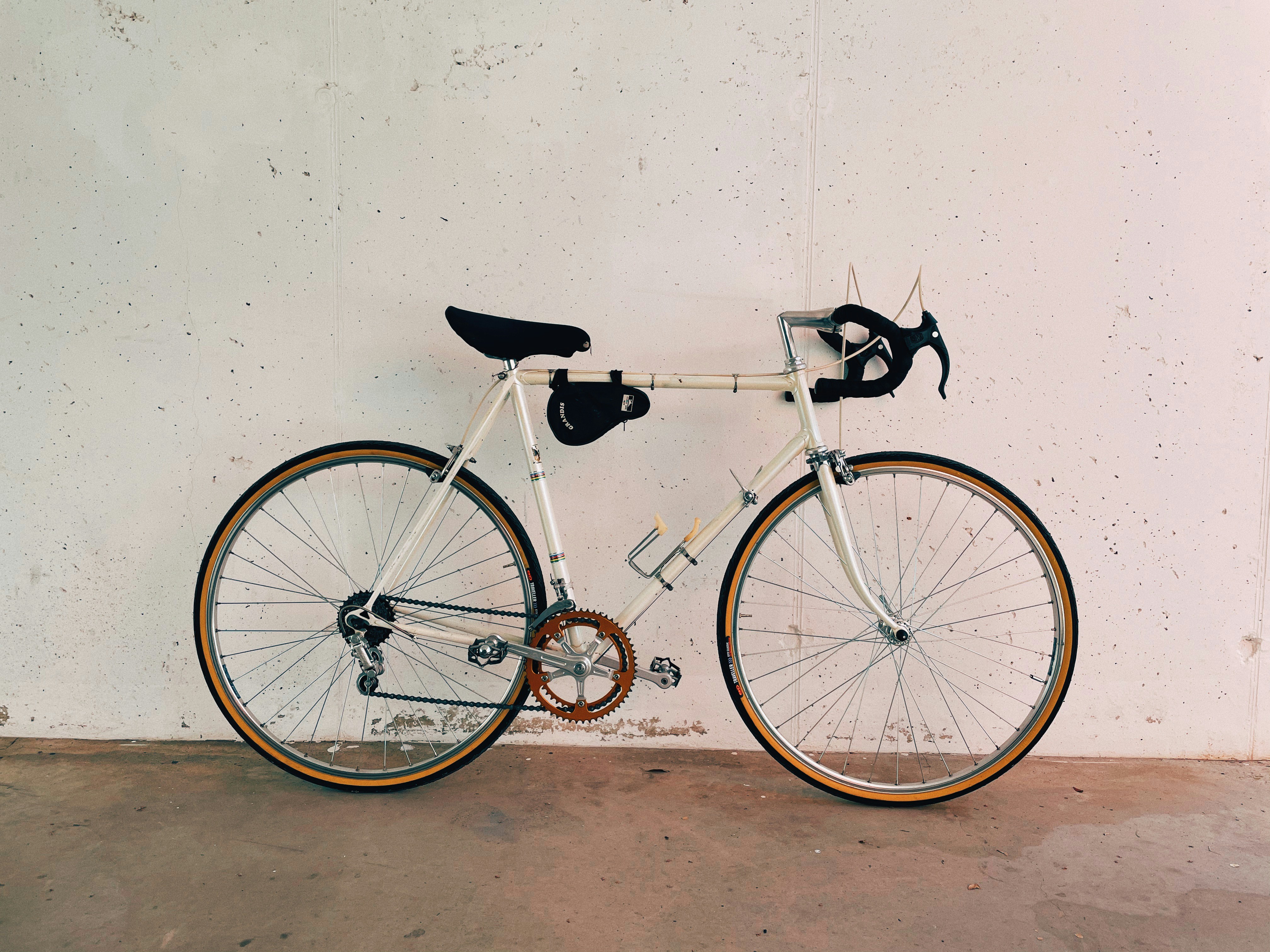 White vintage bicycle with black wheels ready for restoration