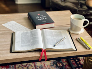 a book and a cup of coffee on a table