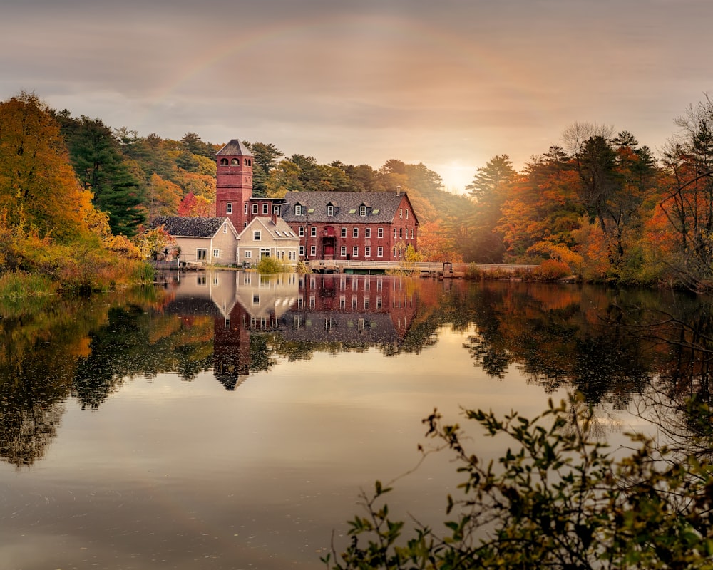 a building on a hill by a body of water