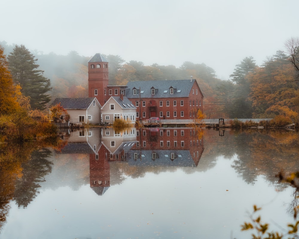 a building on a hill by a body of water