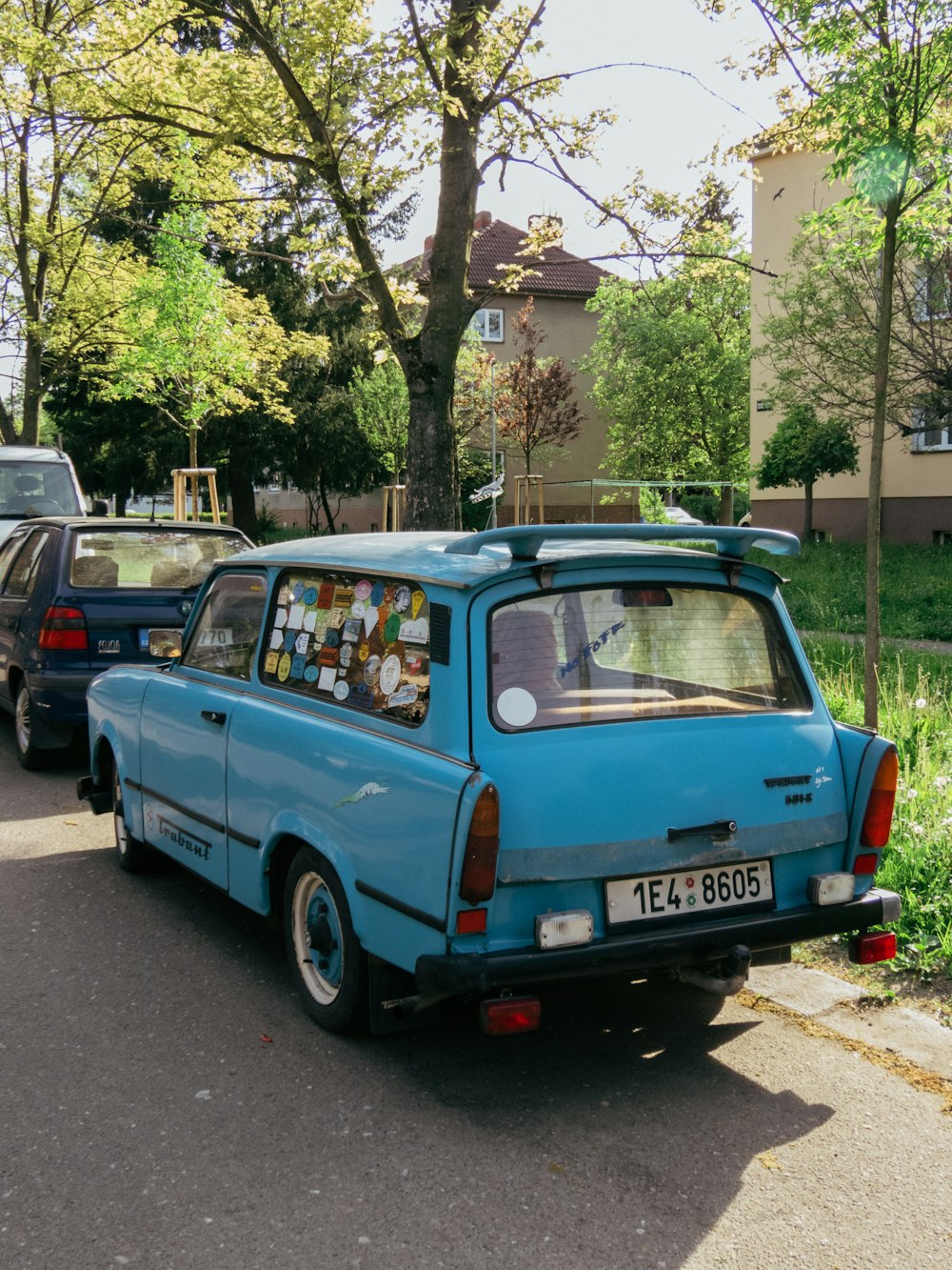 a blue car parked on the side of the road