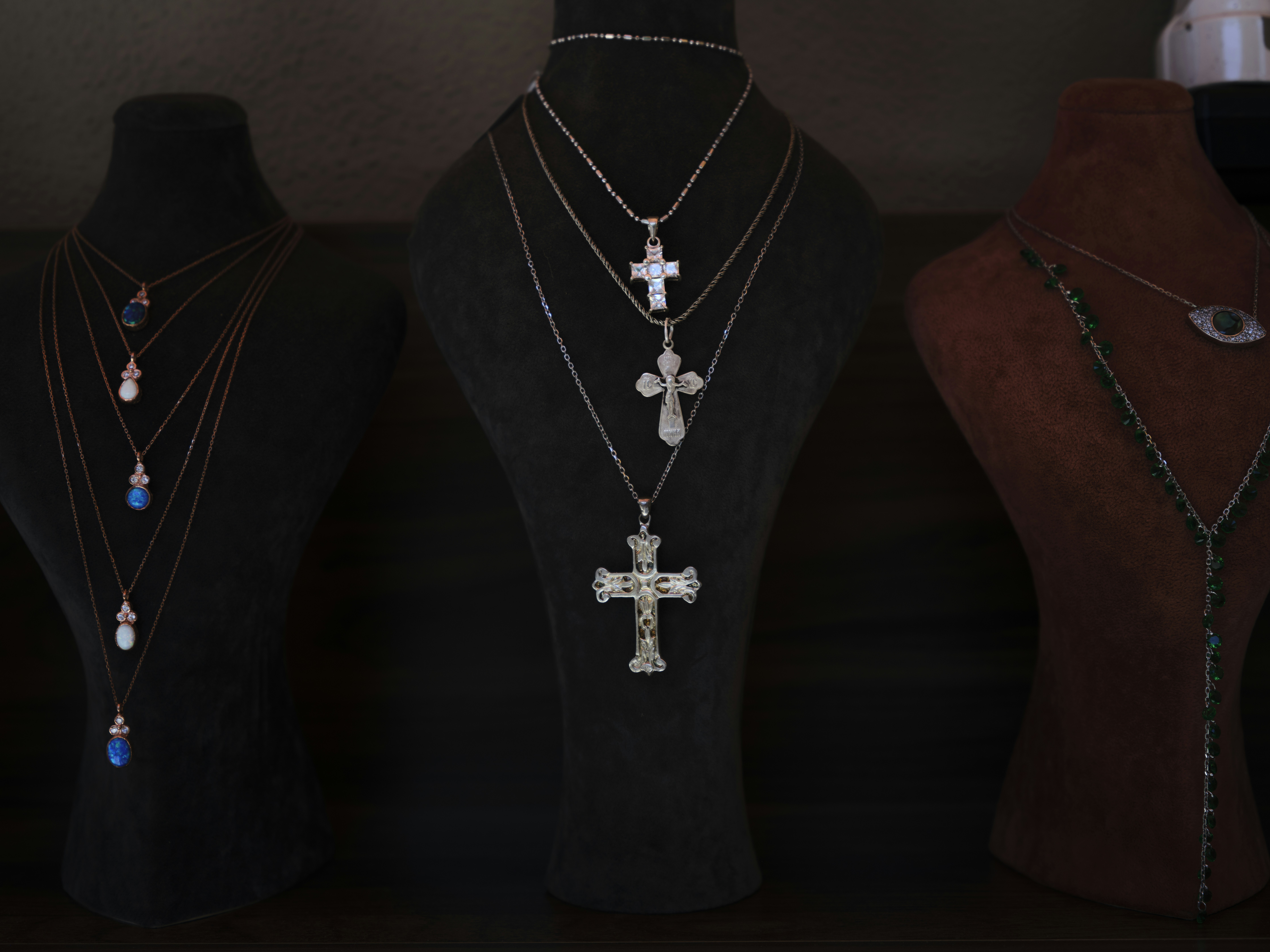 silver cross necklace in a store