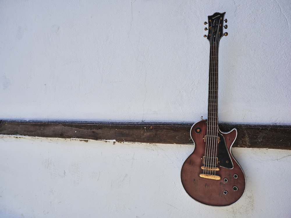 a guitar leaning against a wall