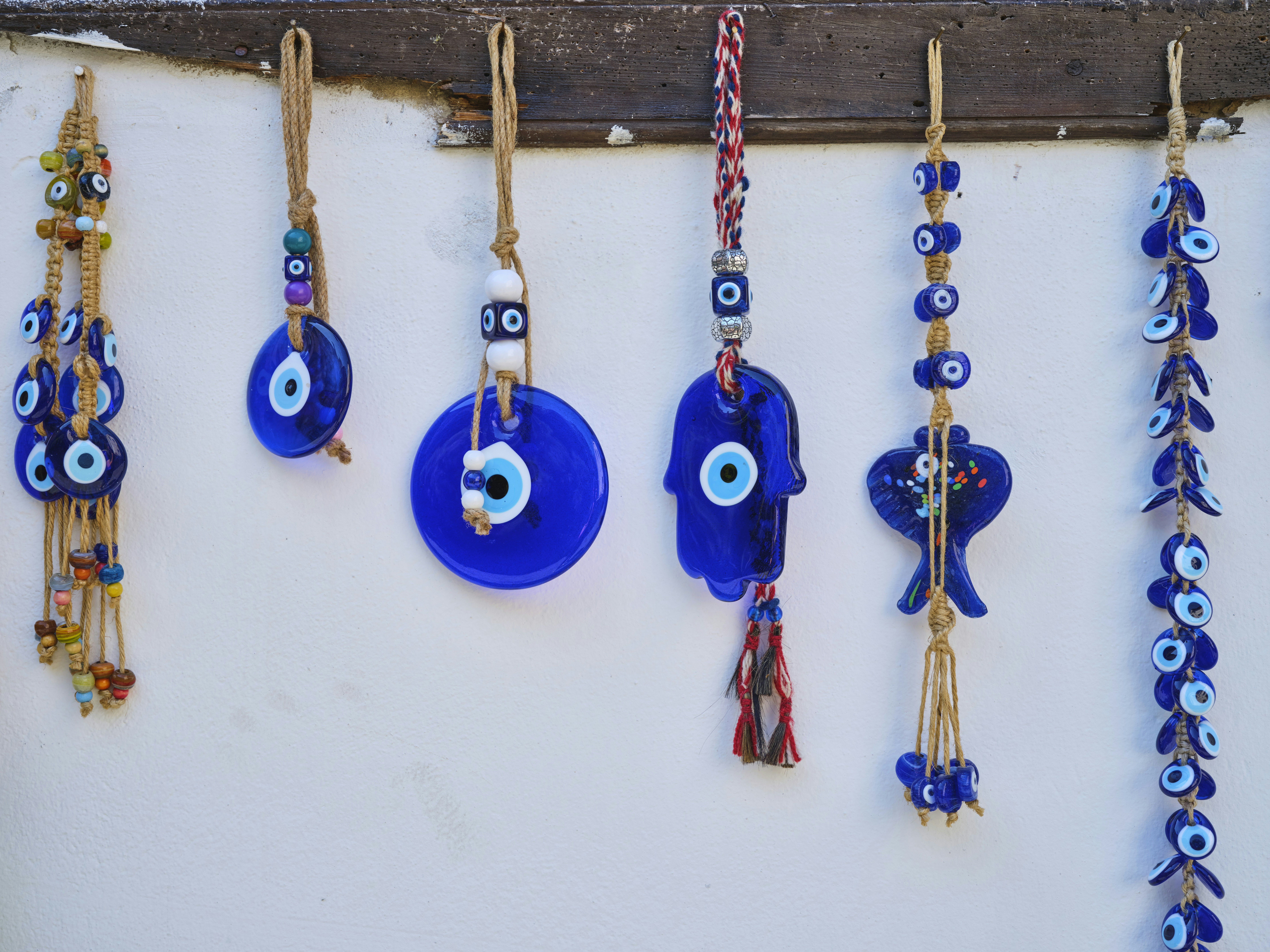 Evil eye tassels hanging on a wall. 
