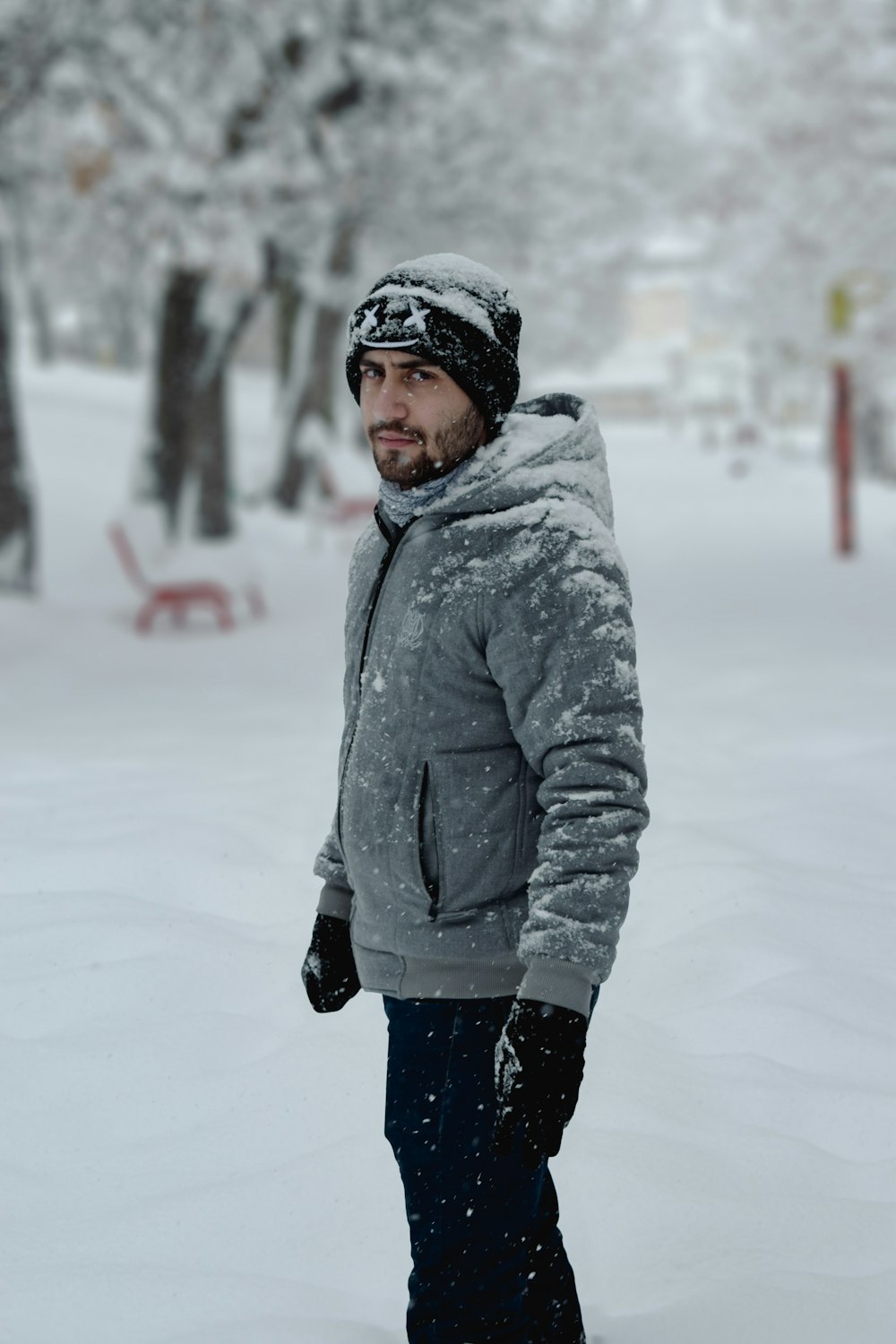 a person wearing a hat and gloves in the snow