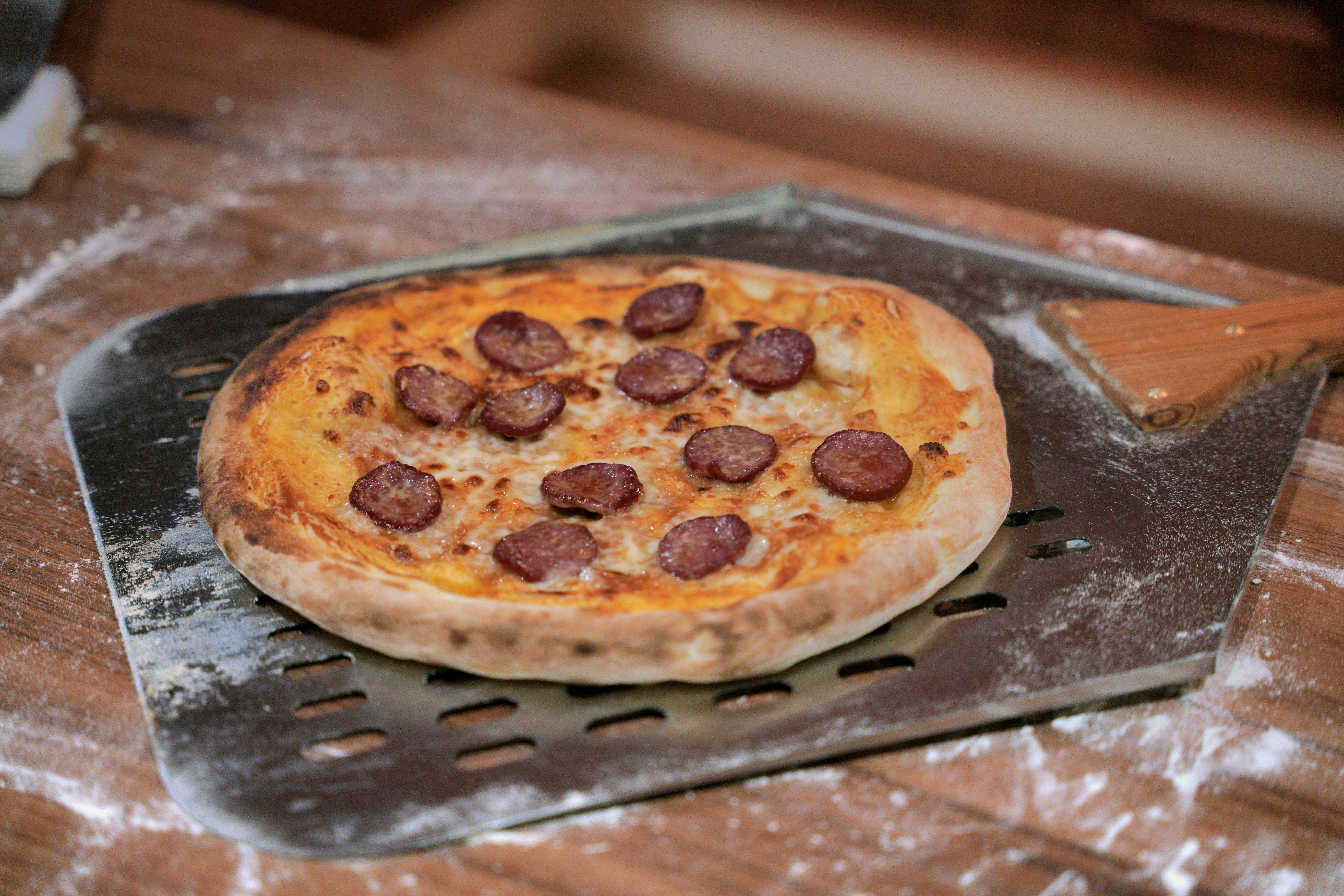 a pepperoni pizza on a metal tray