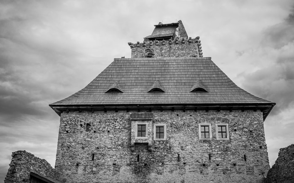 a stone building with a cloudy sky