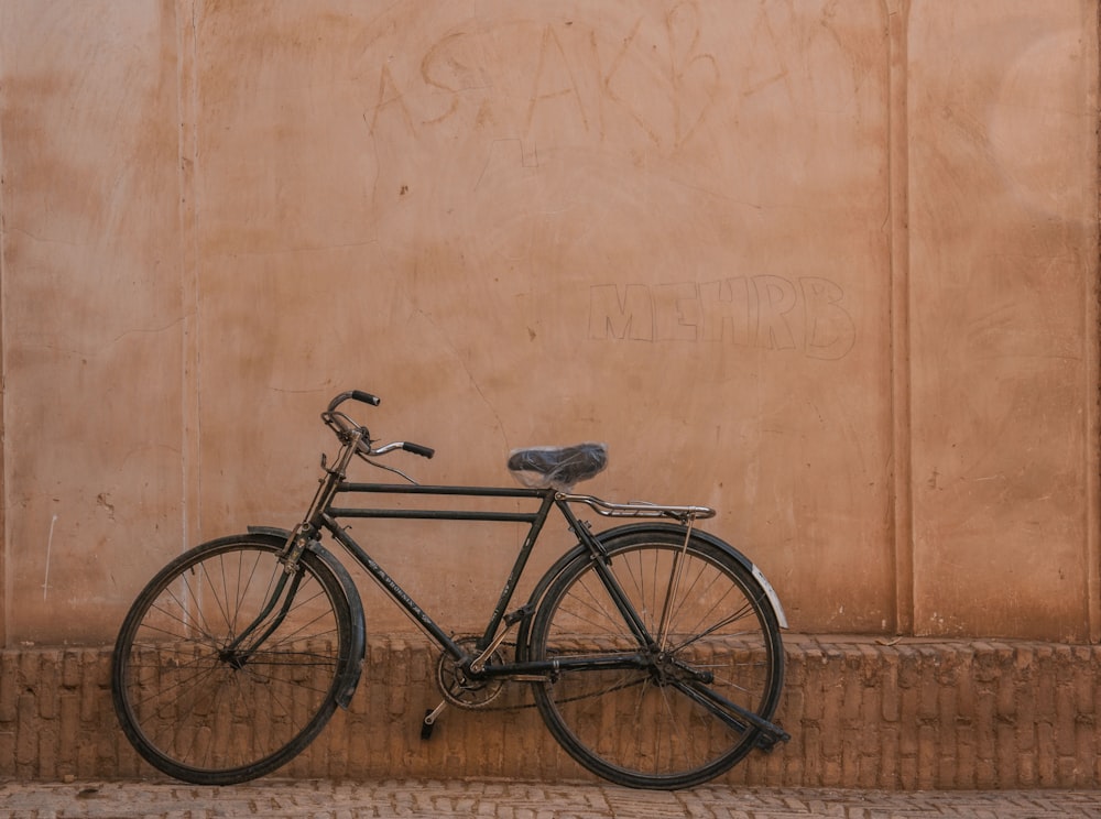 a bike leaning against a wall with graffiti on it