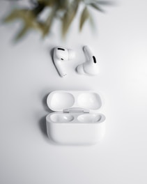 a pair of white earphones sitting on top of a table