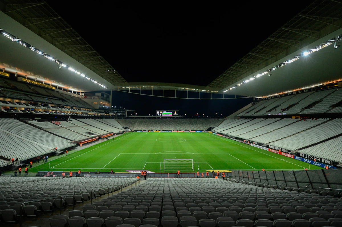 Empty stadium with floodlights on at night, no players or crowd in frame