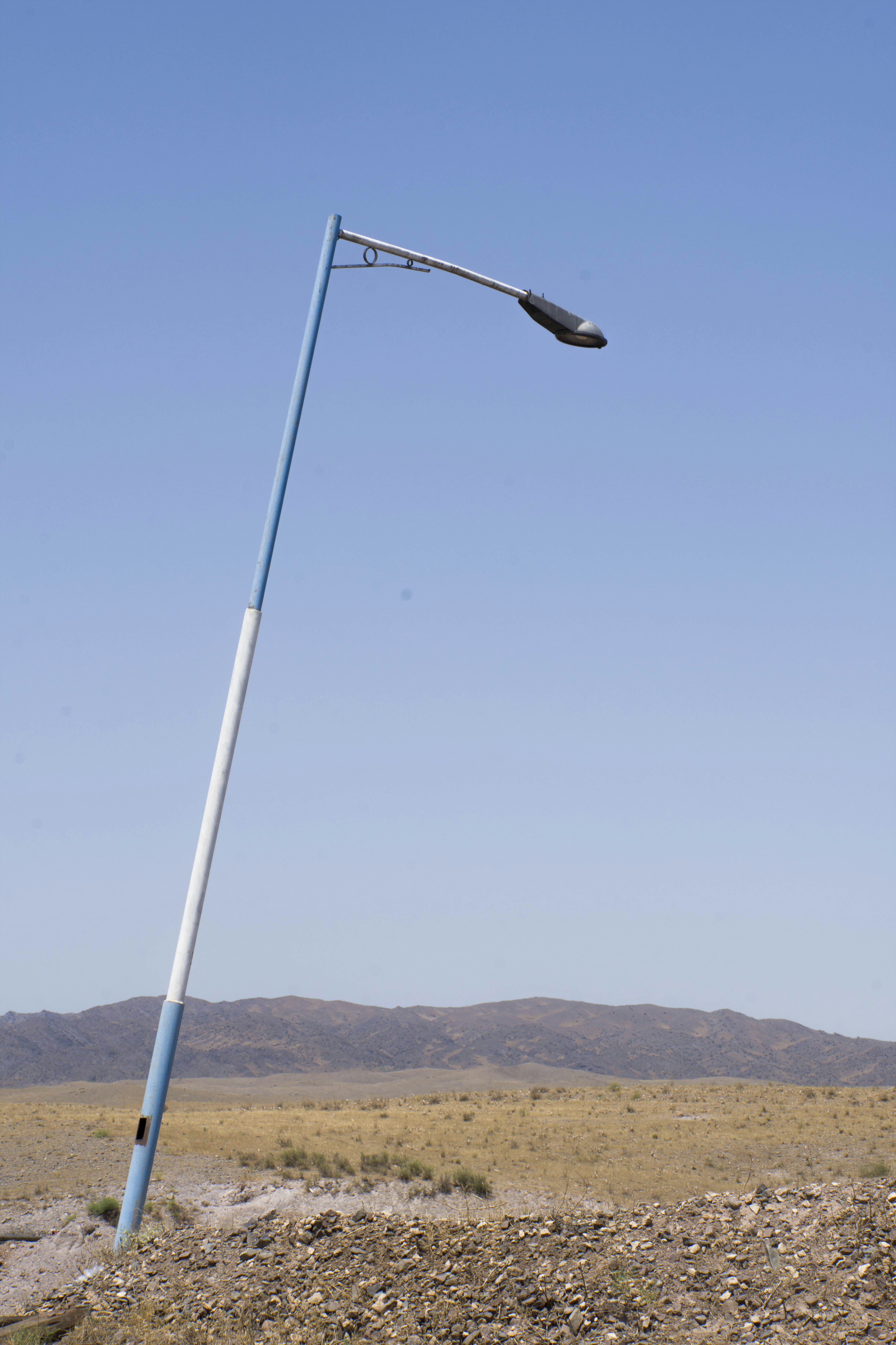 a street light on a pole in the middle of nowhere