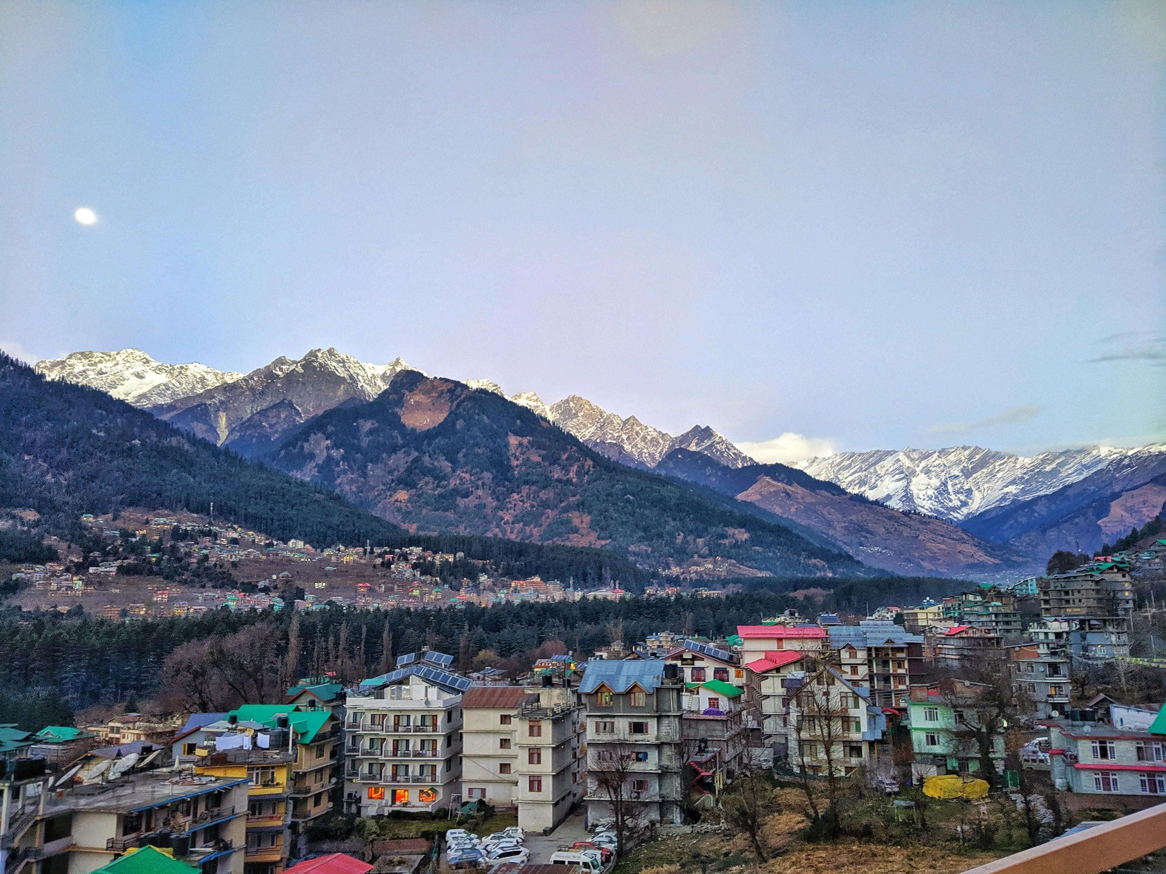a view of a city with mountains in the background, View from the hotel balcony