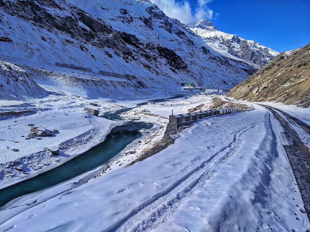 a train traveling through a snow covered mountain side