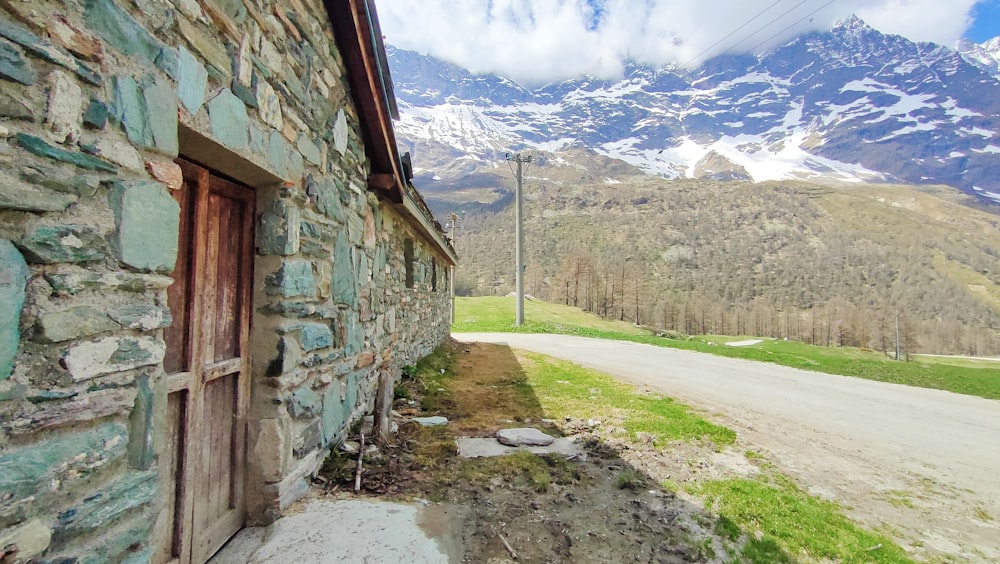 a stone building sitting on the side of a road