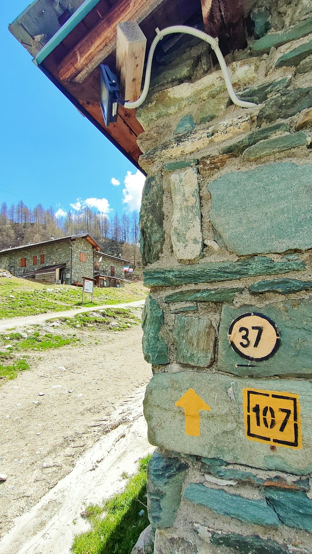 a stone building with a sign on the side of it