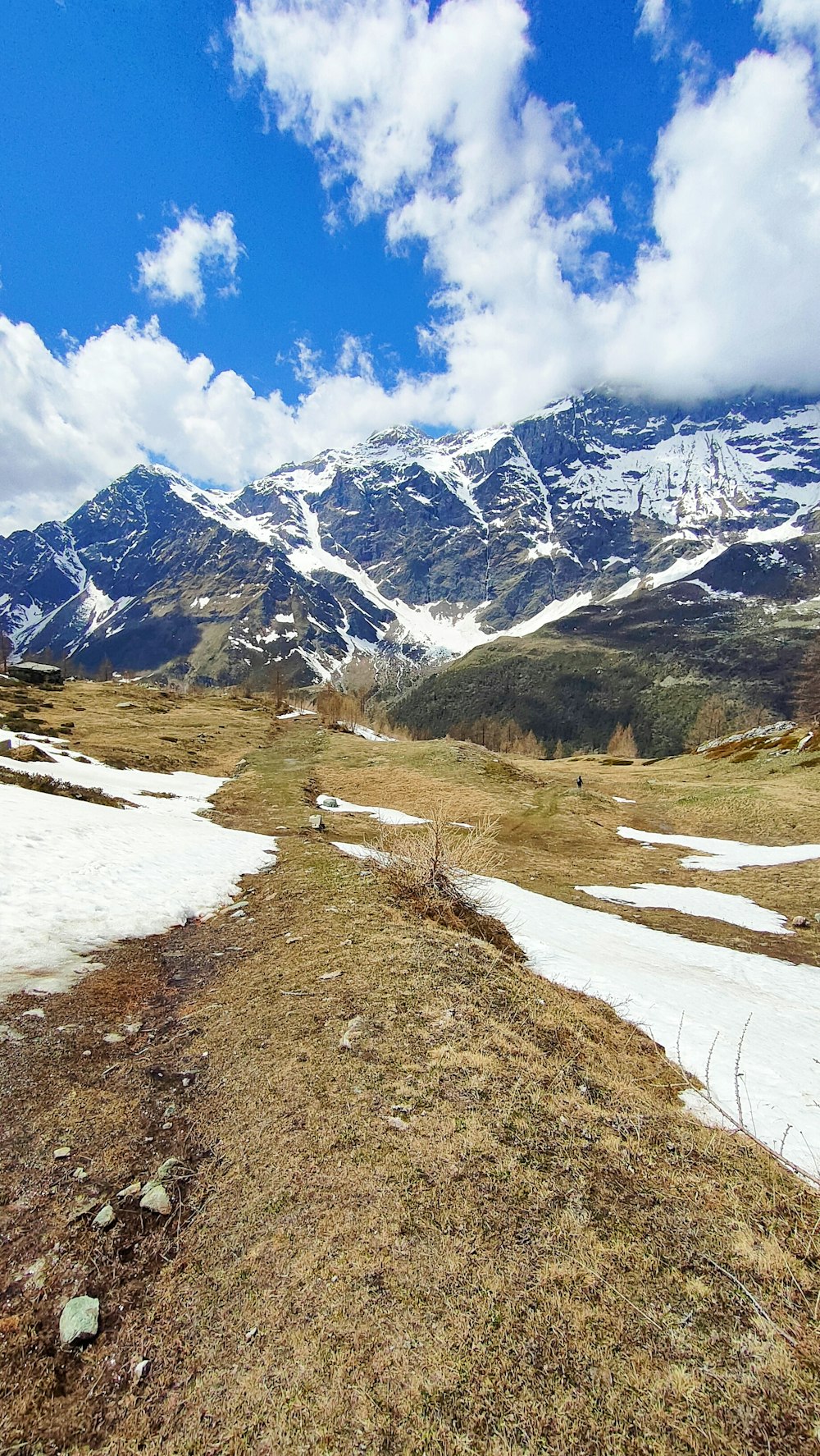 a snow covered mountain range with a snow - capped mountain in the background