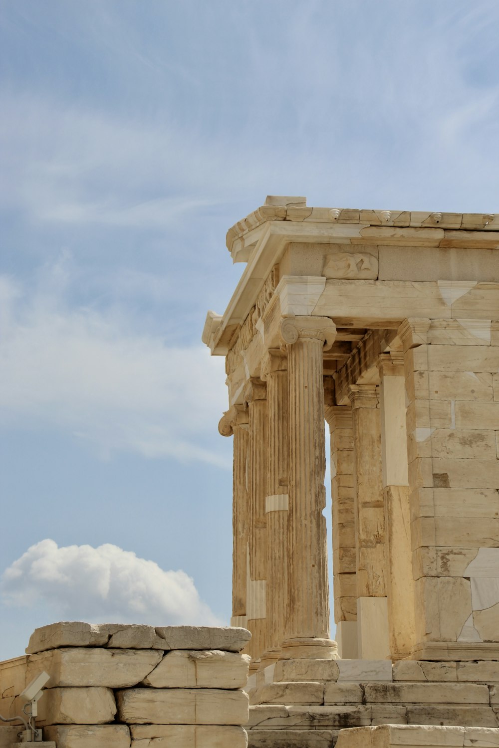 a large stone structure with columns on top of it