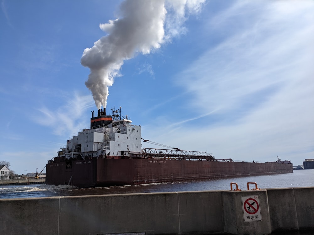a large boat with smoke coming out of it