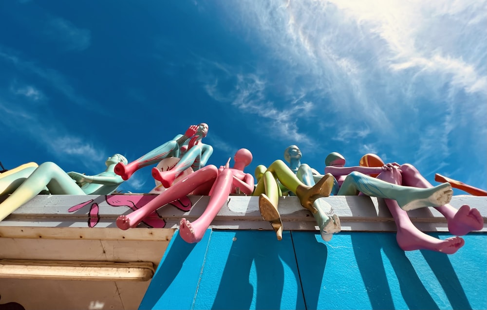 a group of mannequins sitting on top of a building