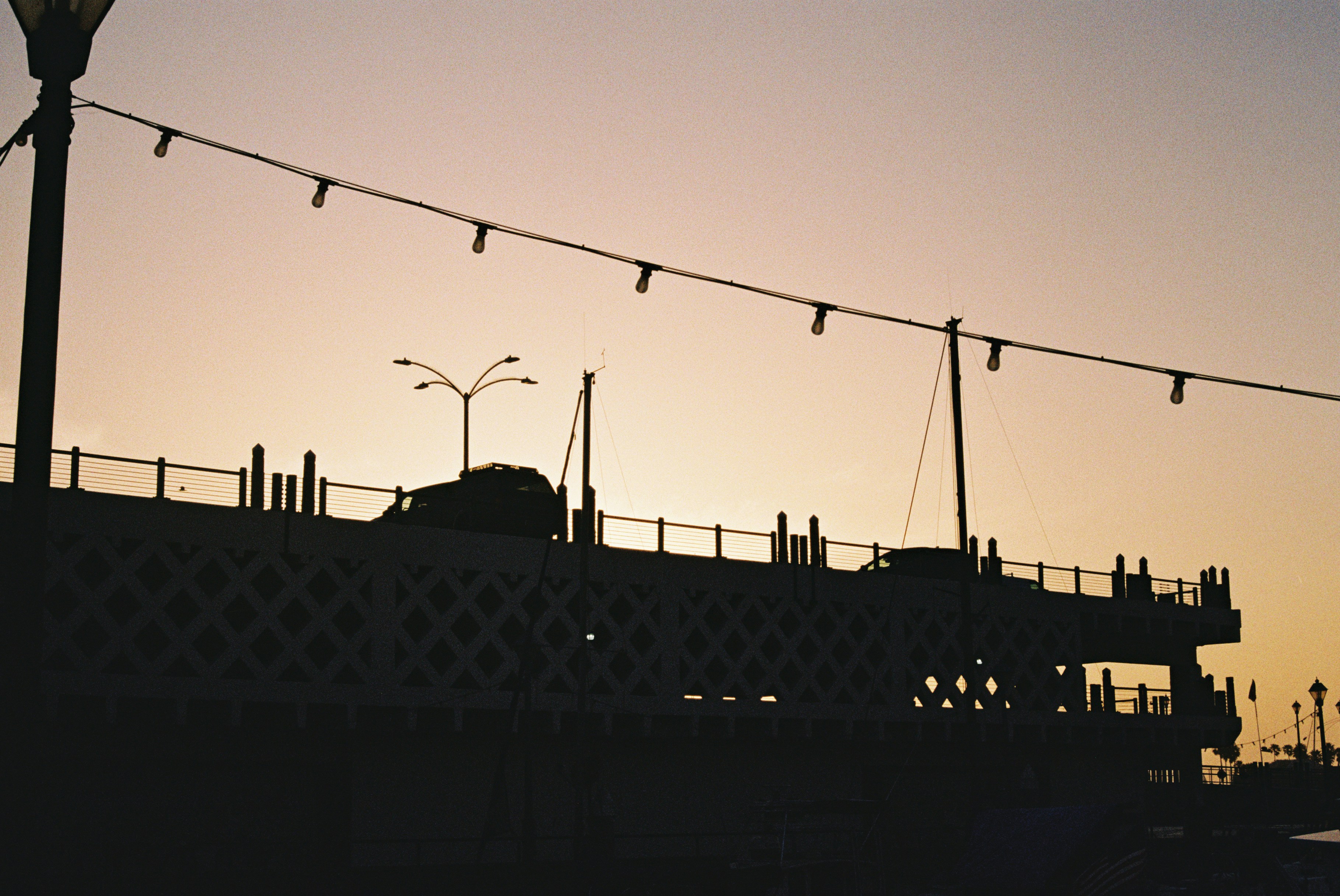 a street light sitting on the side of a bridge