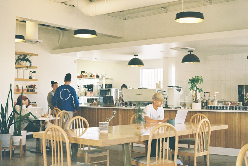 a group of people sitting at a table in a restaurant