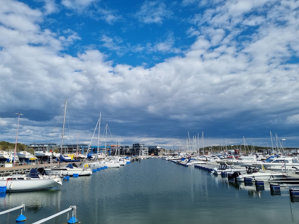 a harbor filled with lots of boats under a cloudy sky