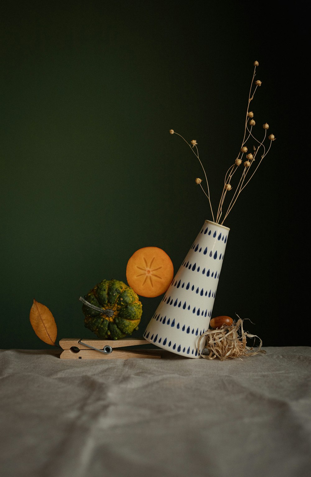 a white and blue vase sitting on top of a table