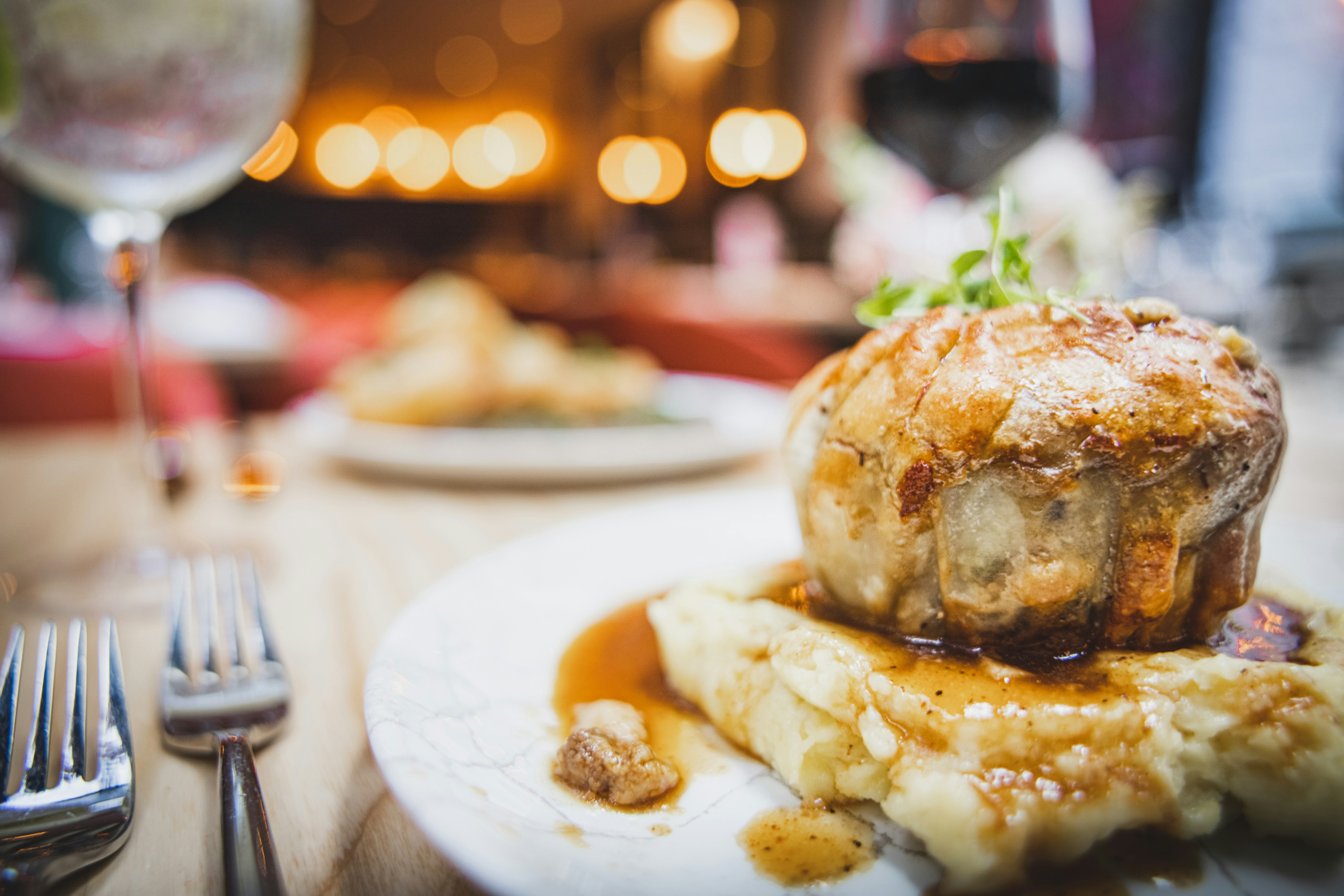 Pie with gravy on a table with fork