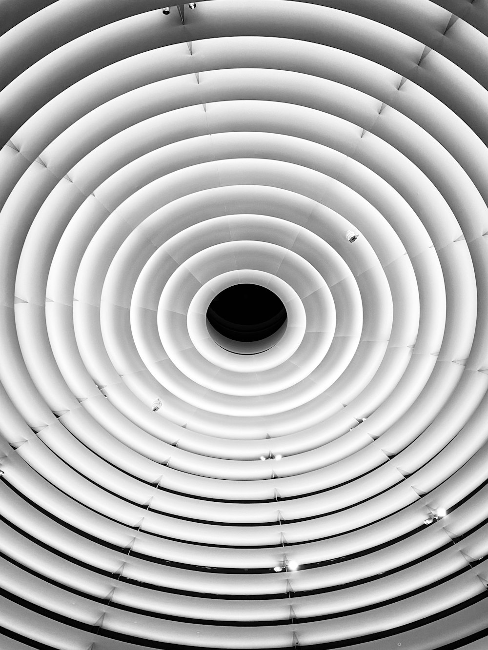 a black and white photo of a circular ceiling