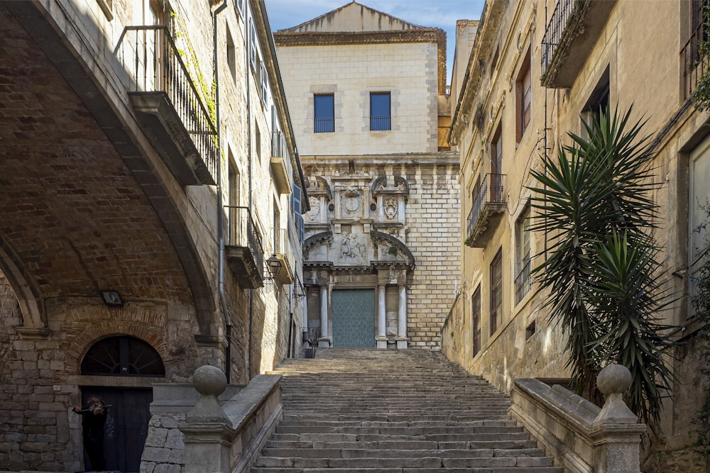 a narrow street with stone steps leading up to a building