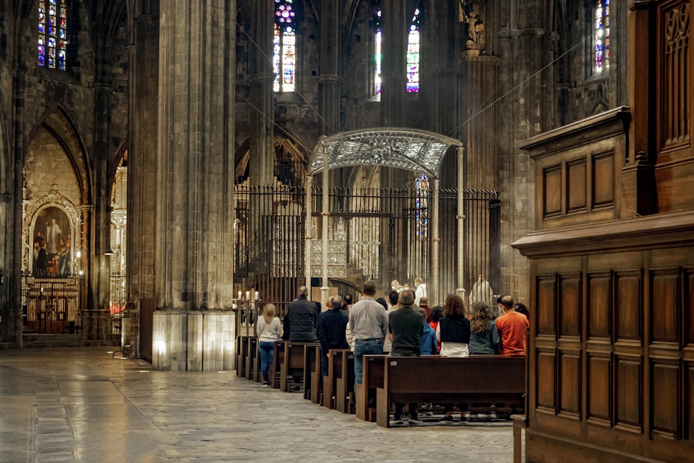 a group of people sitting on benches in a church