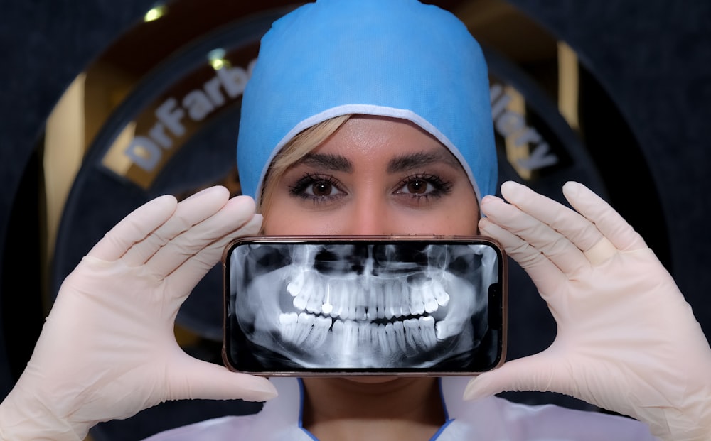 a woman holding a cell phone up to her face