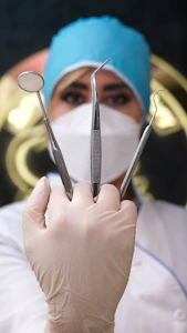 a person wearing a surgical mask holding up a pair of scissors